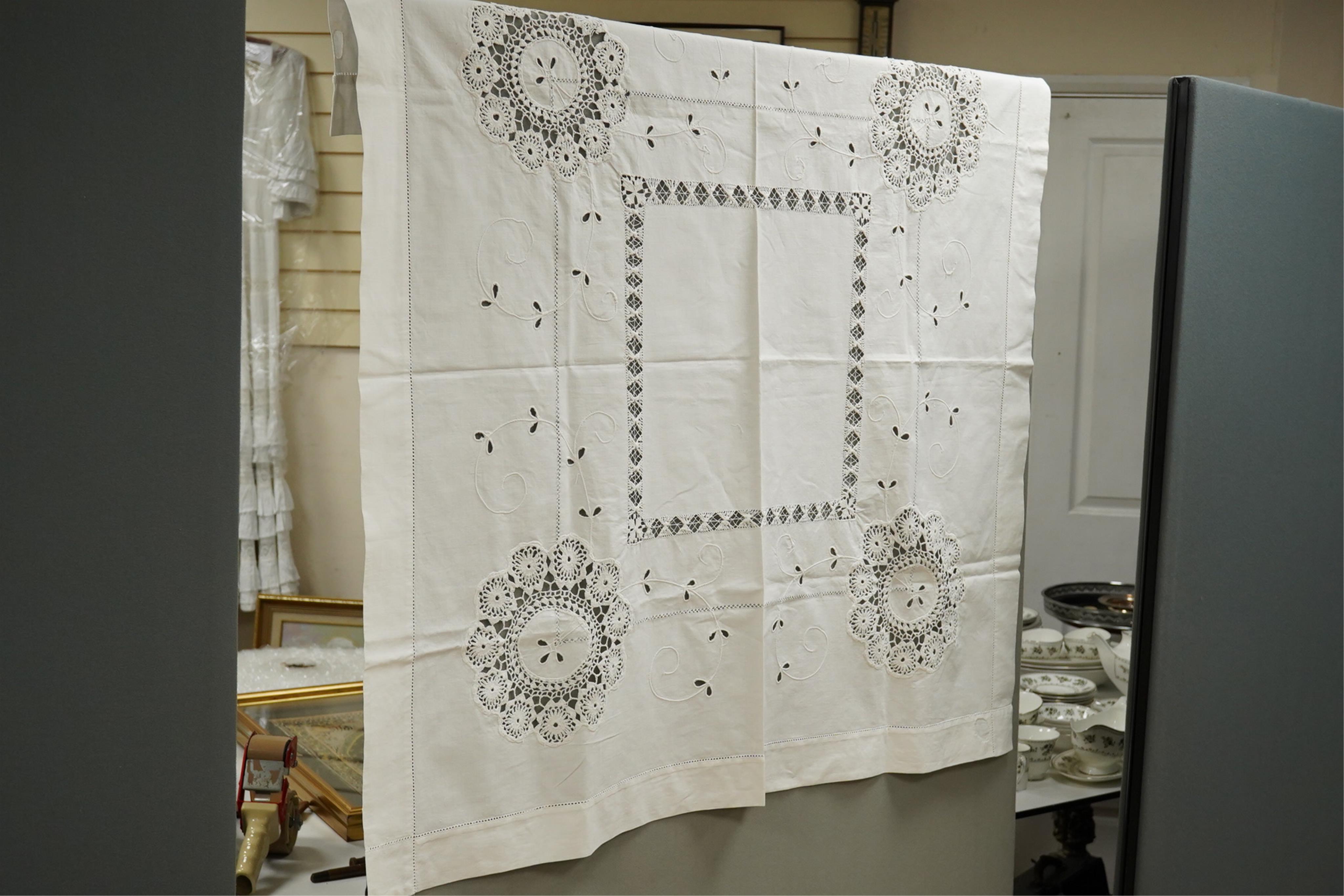 A collection of early 20th century and later crochet, cut work and drawn thread table linens and a large embroidered table cloth